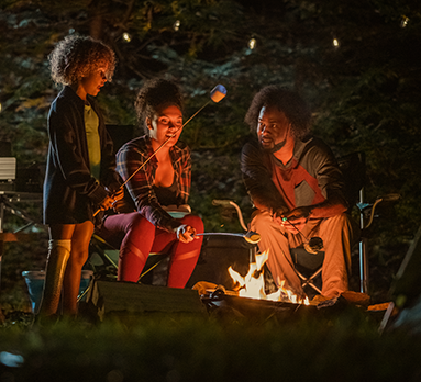 Family enjoying a fire outside